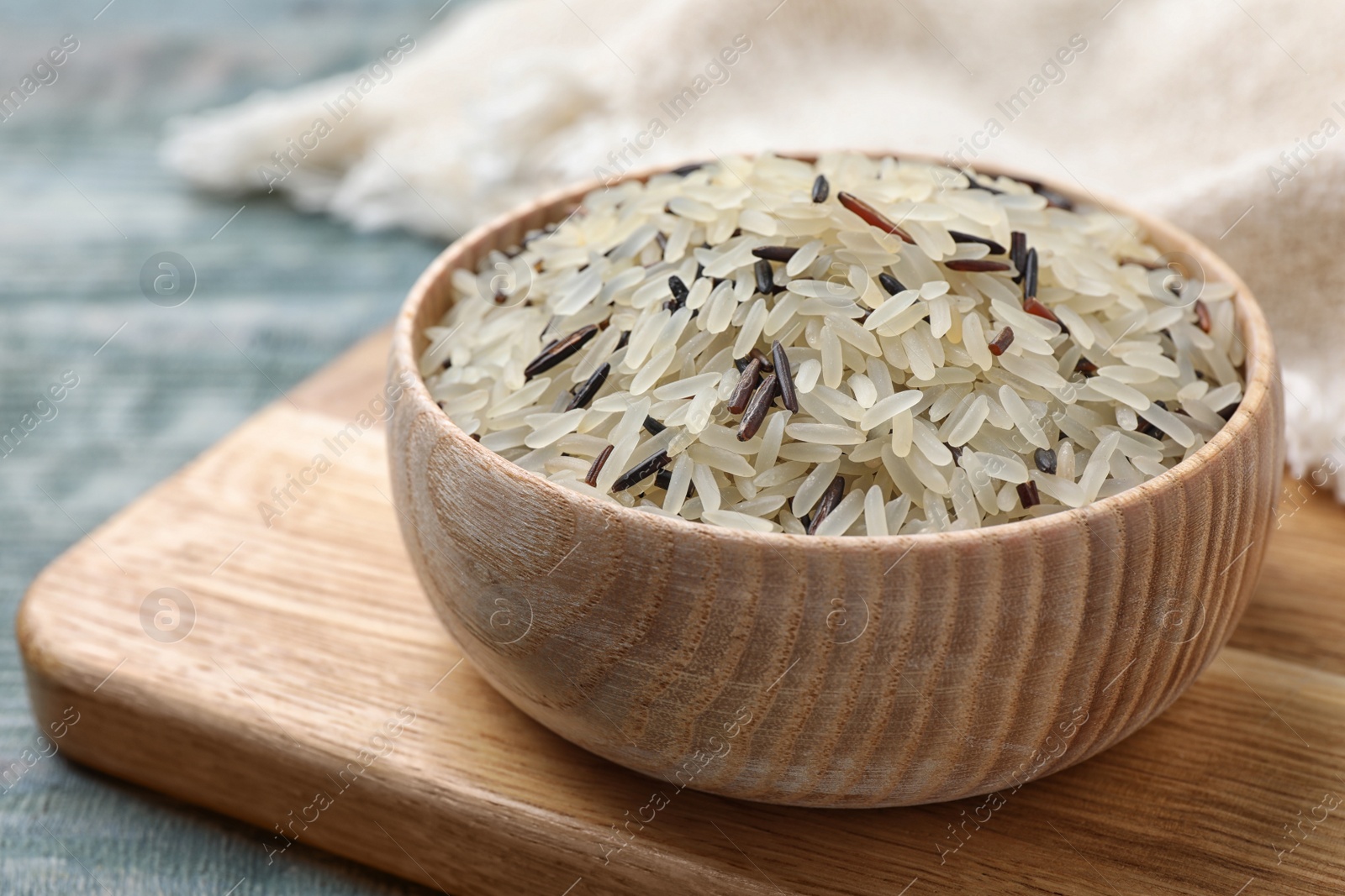 Photo of Mix of brown and polished rice on wooden table