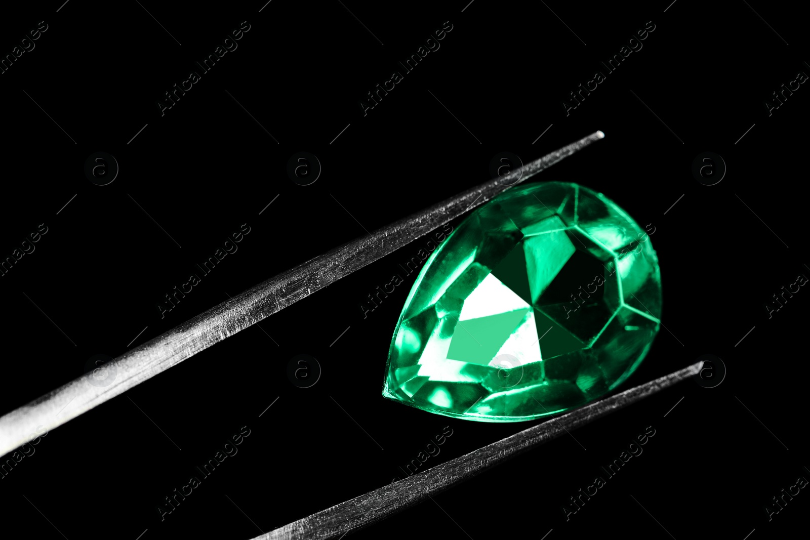 Photo of Tweezers with beautiful gemstone on black background