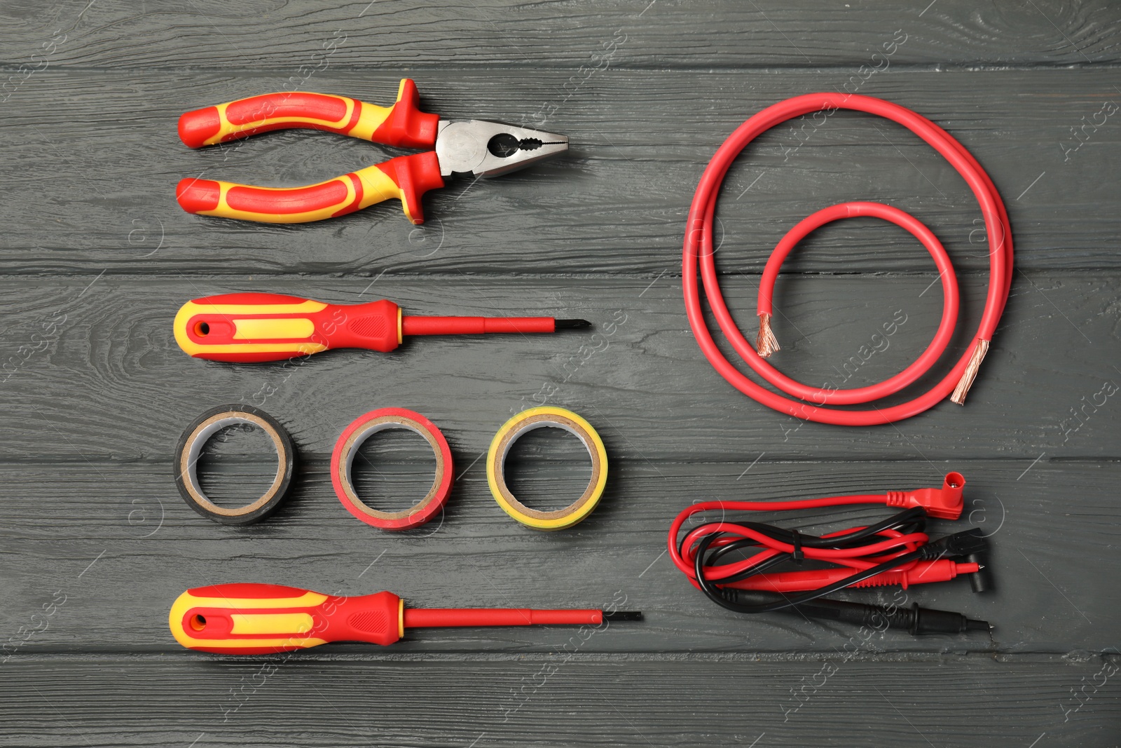 Photo of Flat lay composition with electrician's tools on wooden background