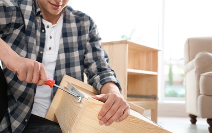 Photo of Man working with drawer indoors, closeup. Space for text