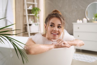 Photo of Beautiful woman enjoying bubble bath at home