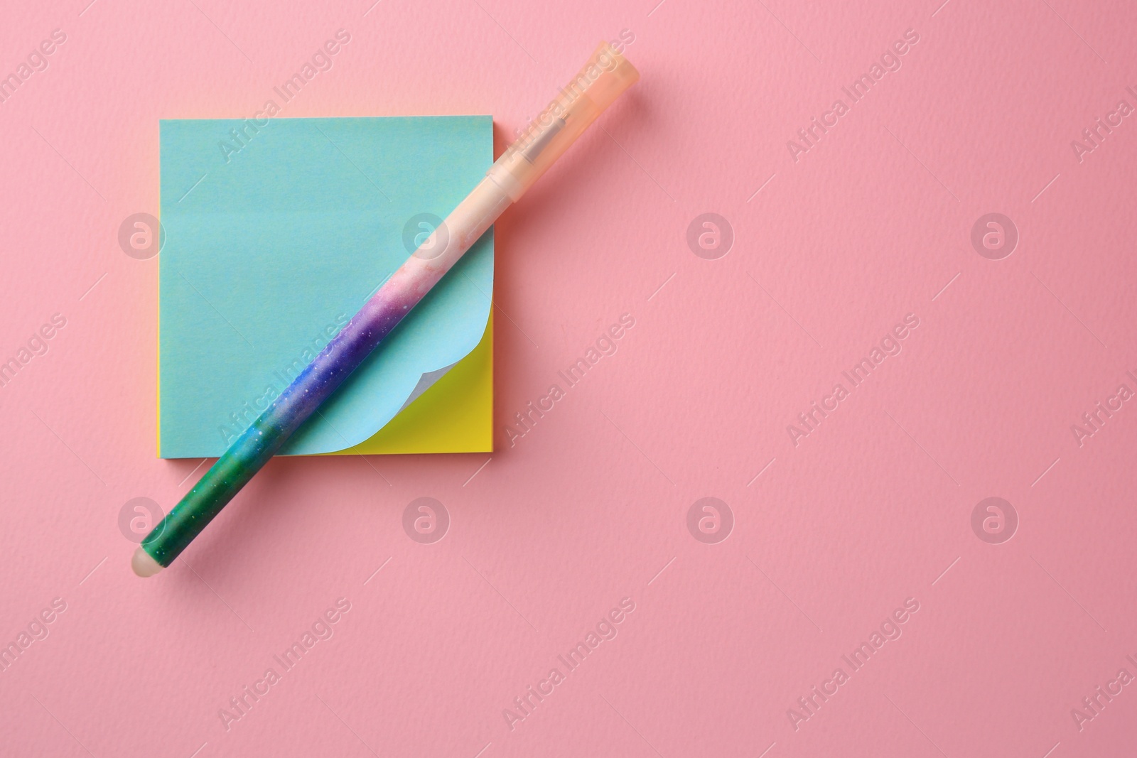 Photo of Blank paper notes and pen on pink background, top view. Space for text