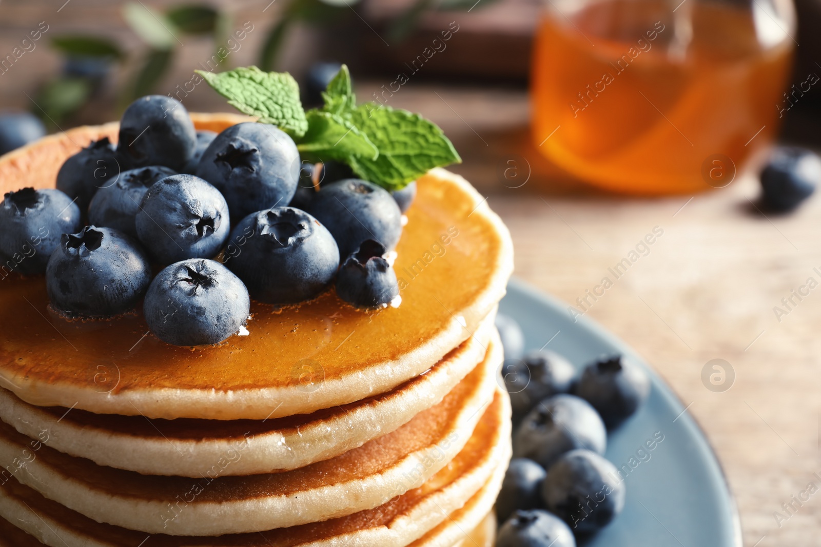 Photo of Plate with pancakes and berries on table, closeup