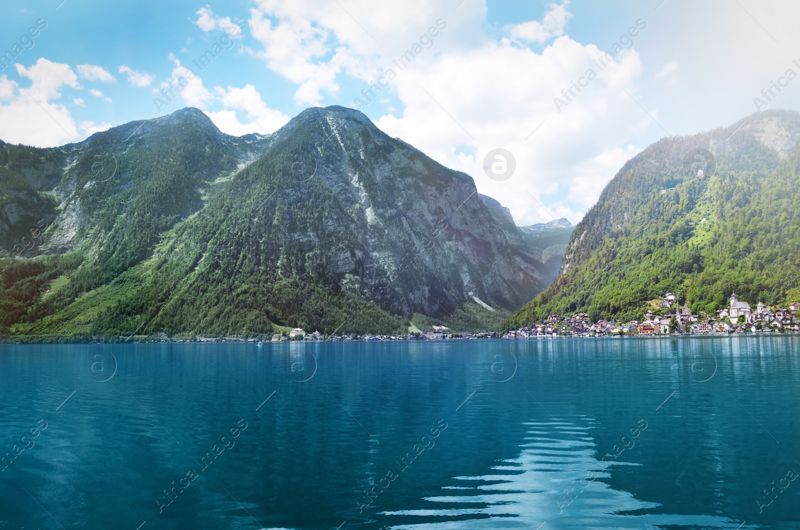 Photo of Picturesque view of small resort town near mountains on riverside