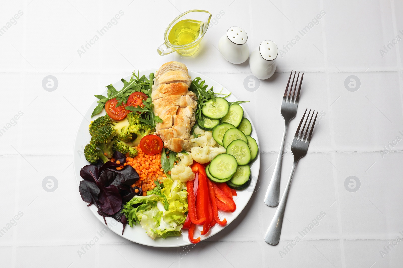 Photo of Balanced diet and healthy foods. Plate with different delicious products on white tiled table, flat lay