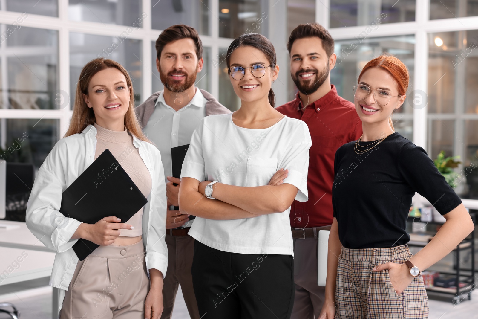 Photo of Portrait of happy employees in office. Team work