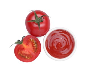 Photo of Bowl with tasty ketchup and fresh tomatoes isolated on white, top view