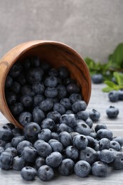 Photo of Tasty fresh blueberries on wooden table, closeup
