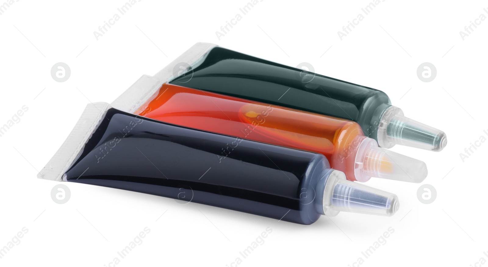 Photo of Tubes with different food coloring on white background