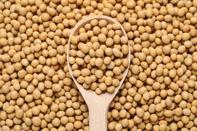 Photo of Closeup of soy with wooden spoon, top view