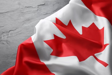 Flag of Canada on black table, closeup
