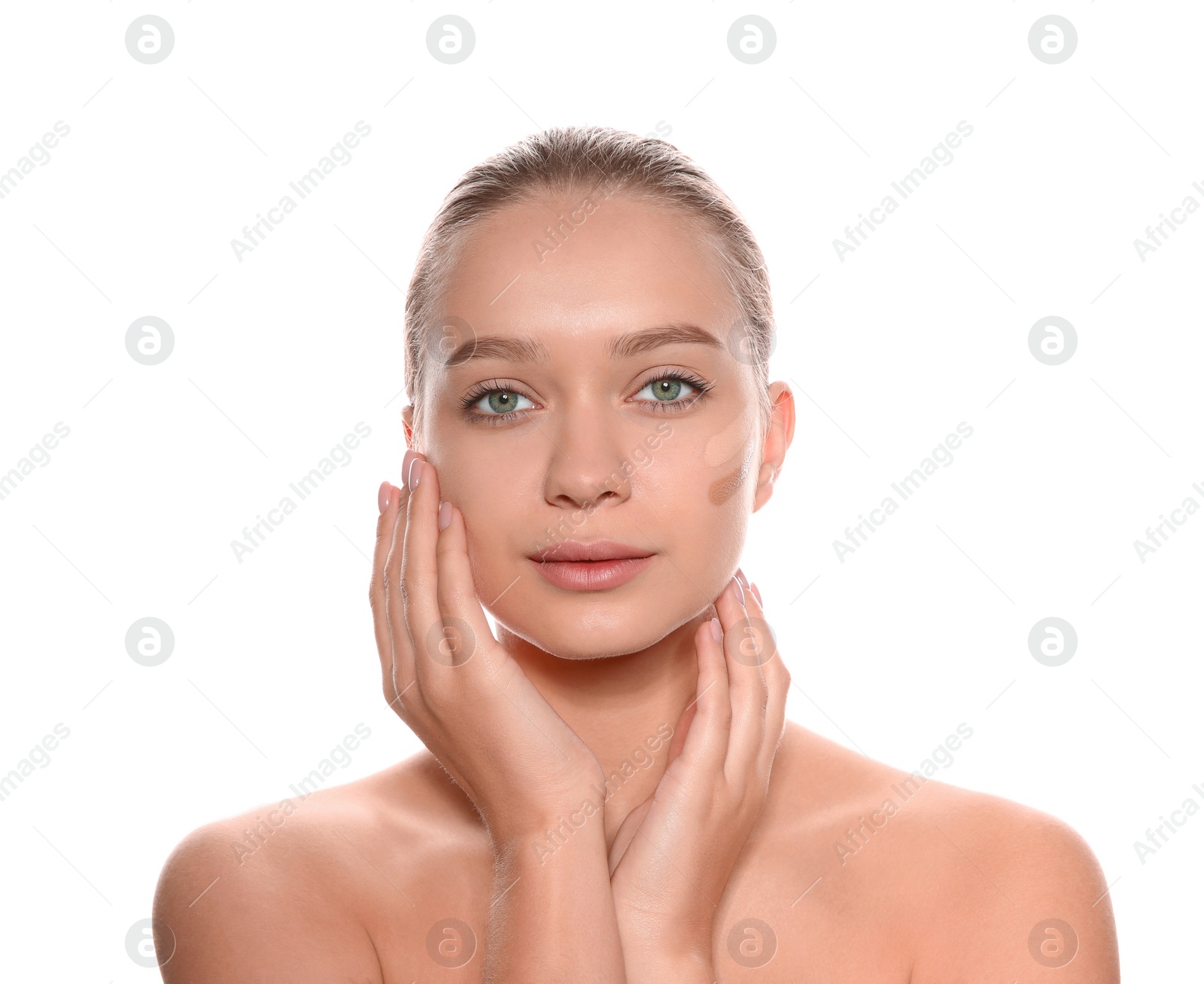 Photo of Young woman with different shades of skin foundation on her face against white background