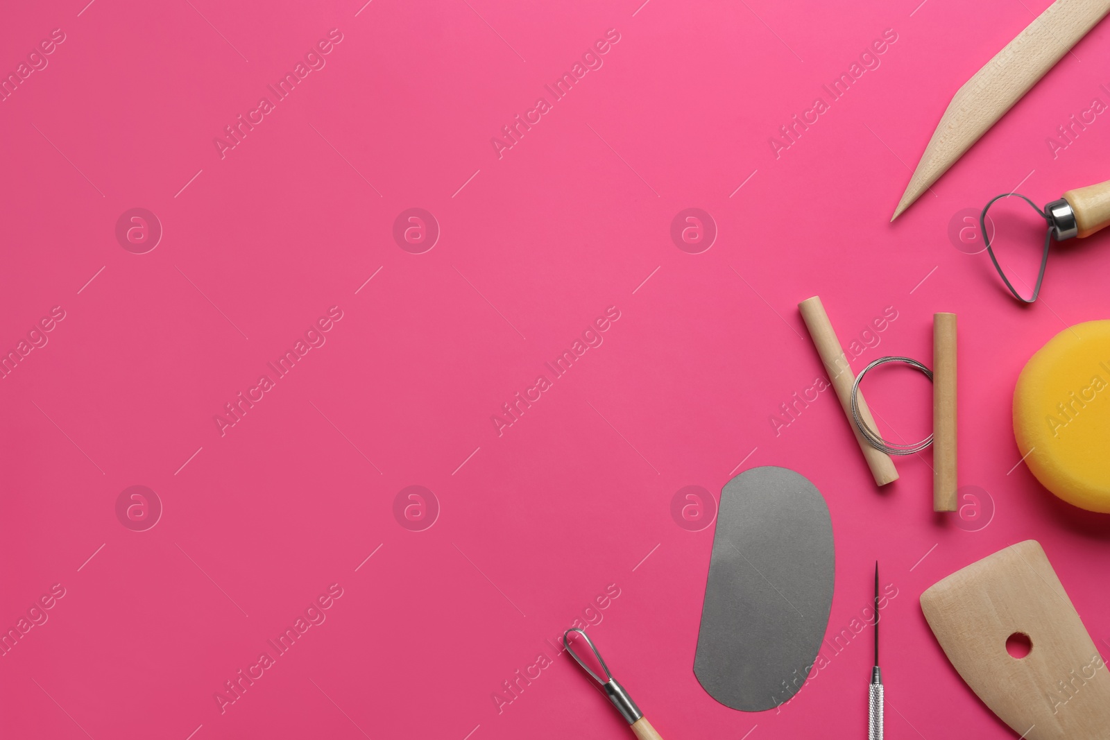 Photo of Set of clay modeling tools on pink background, flat lay. Space for text