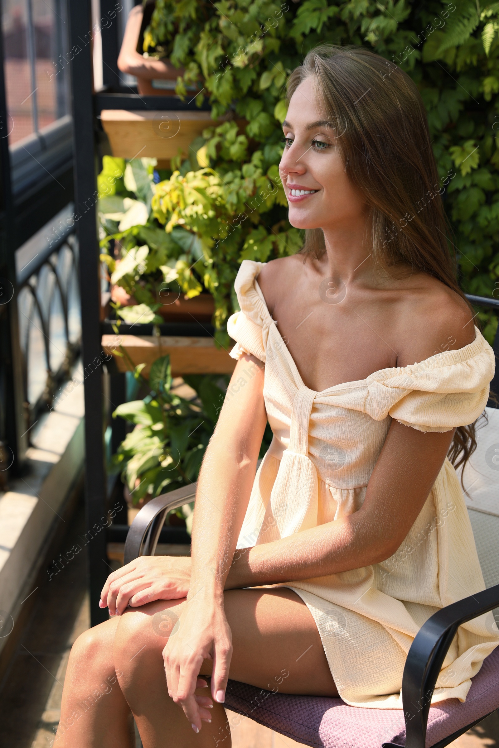 Photo of Beautiful young woman enjoying her time on balcony