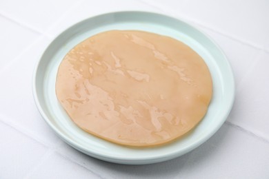 Photo of Making kombucha. Scoby fungus on white tiled table