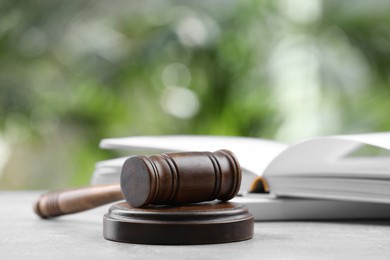 Photo of Wooden gavel on grey table against blurred background
