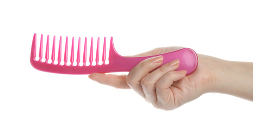 Woman holding hair comb on white background, closeup