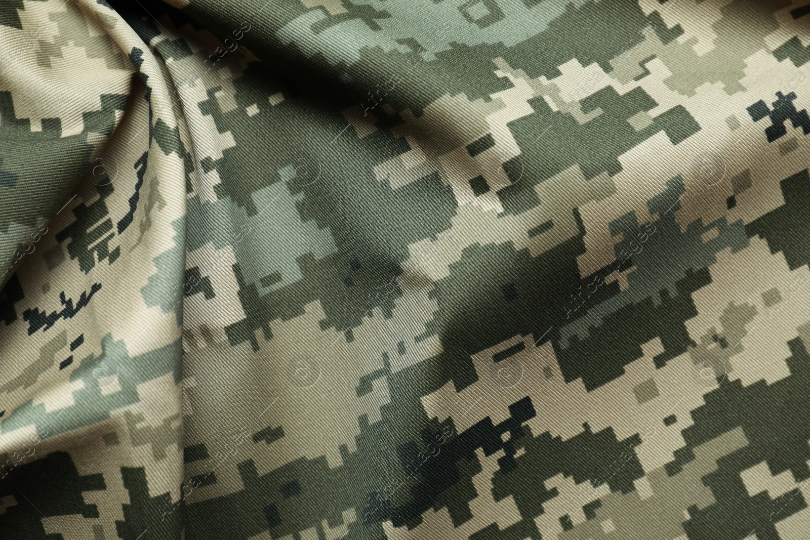 Photo of Texture of crumpled camouflage fabric as background, top view