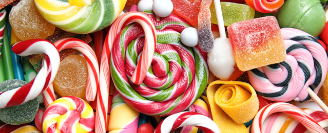 Image of Many different yummy candies as background, top view. Banner design 