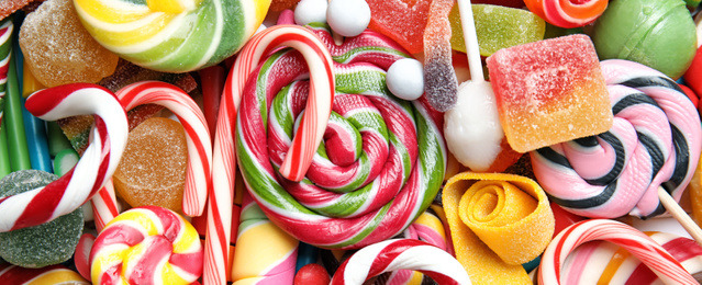 Many different yummy candies as background, top view. Banner design 