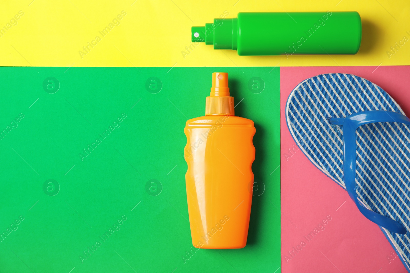 Photo of Flat lay composition with sun protection products and space for text on color background