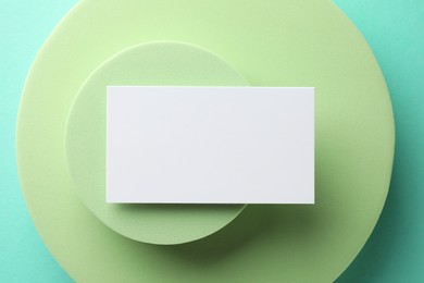 Photo of Empty business card and decorative elements on light blue background, top view. Mockup for design