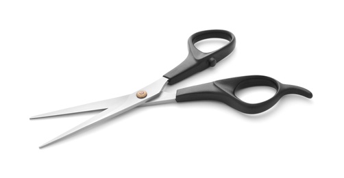 Photo of New scissors isolated on white. Professional hairdresser tool