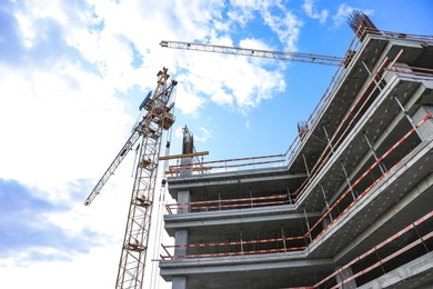 Photo of Unfinished building against blue sky. Construction safety rules