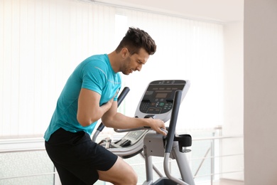 Photo of Young man having heart attack on treadmill in gym