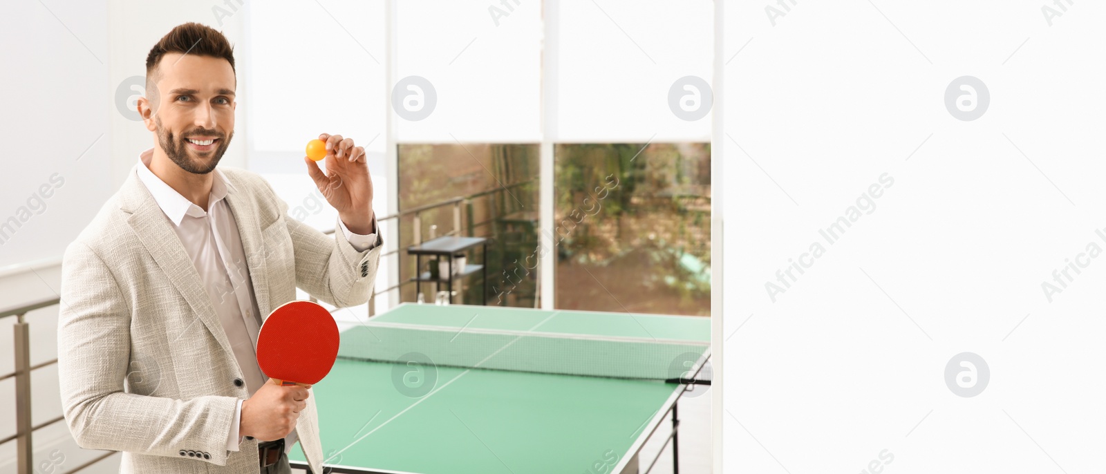 Image of Businessman with tennis racket and ball near ping pong table in office. Space for text. Banner design