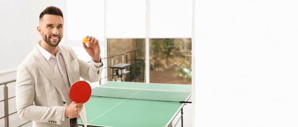 Businessman with tennis racket and ball near ping pong table in office. Space for text. Banner design