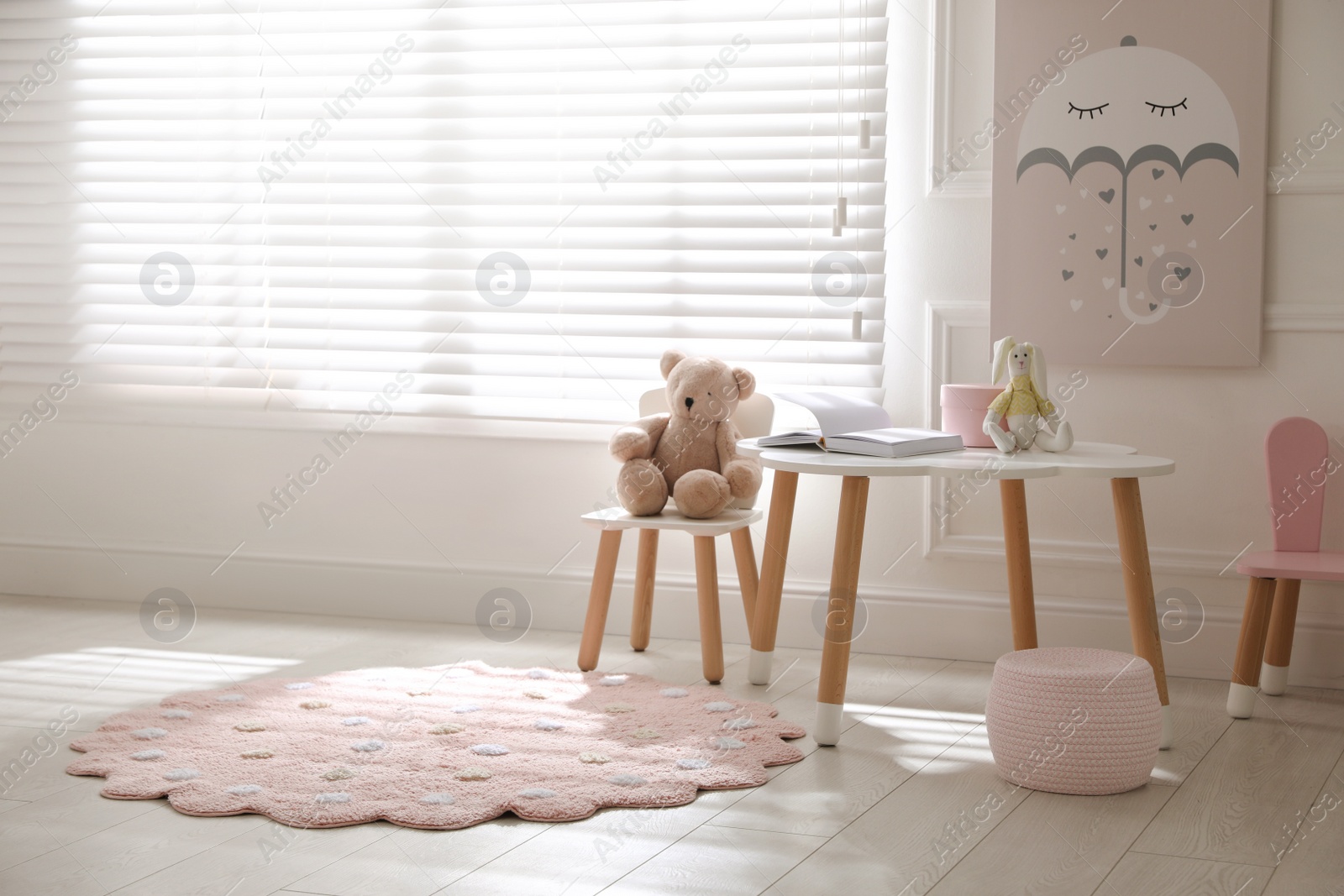 Photo of Round pink rug on floor in children's room