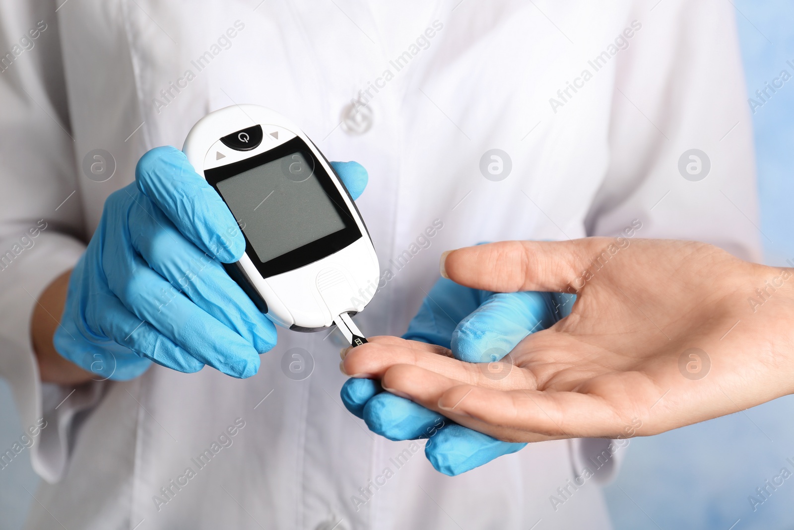 Photo of Doctor checking blood sugar level with glucometer. Diabetes test
