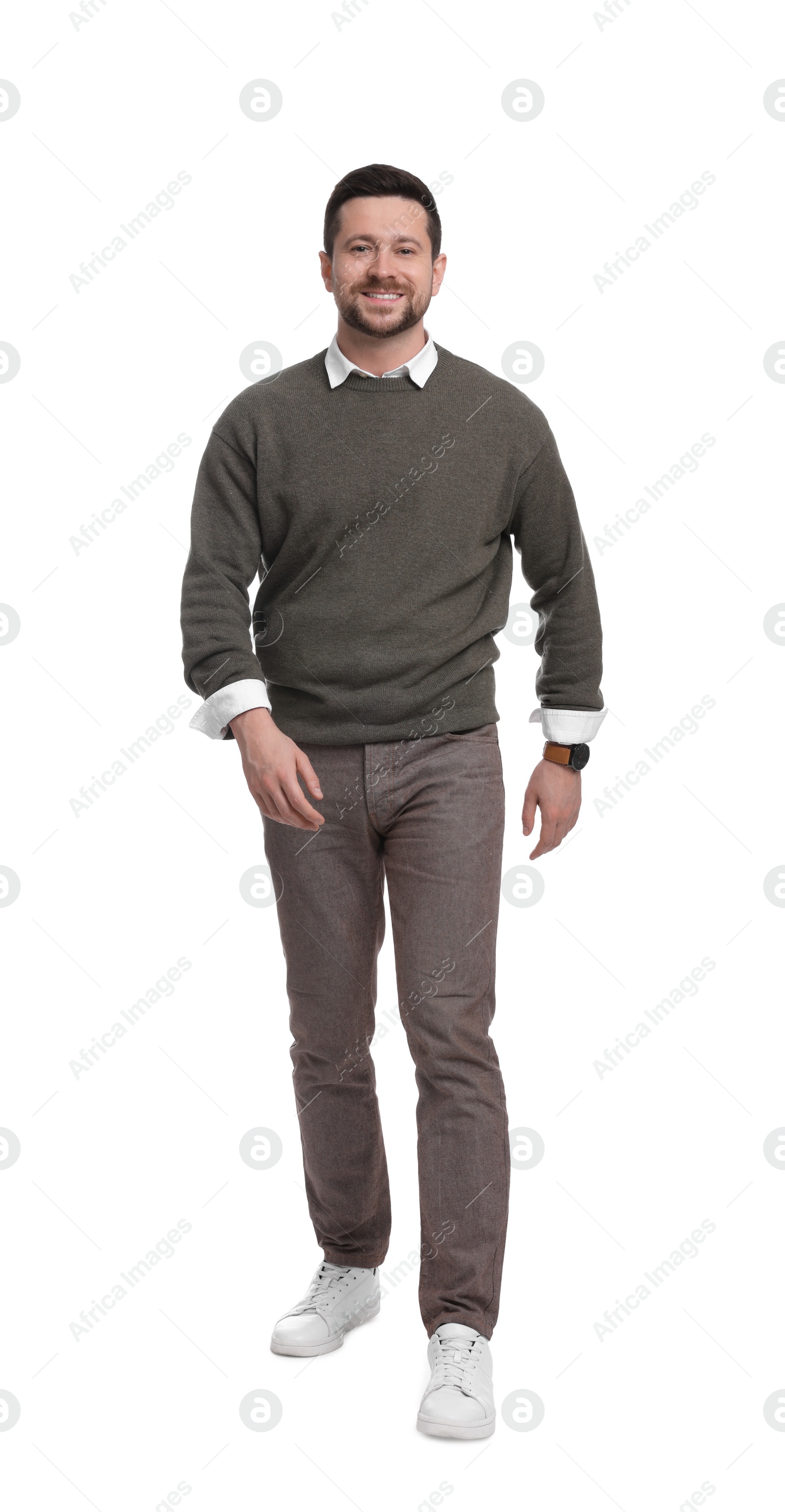 Photo of Handsome bearded businessman walking on white background