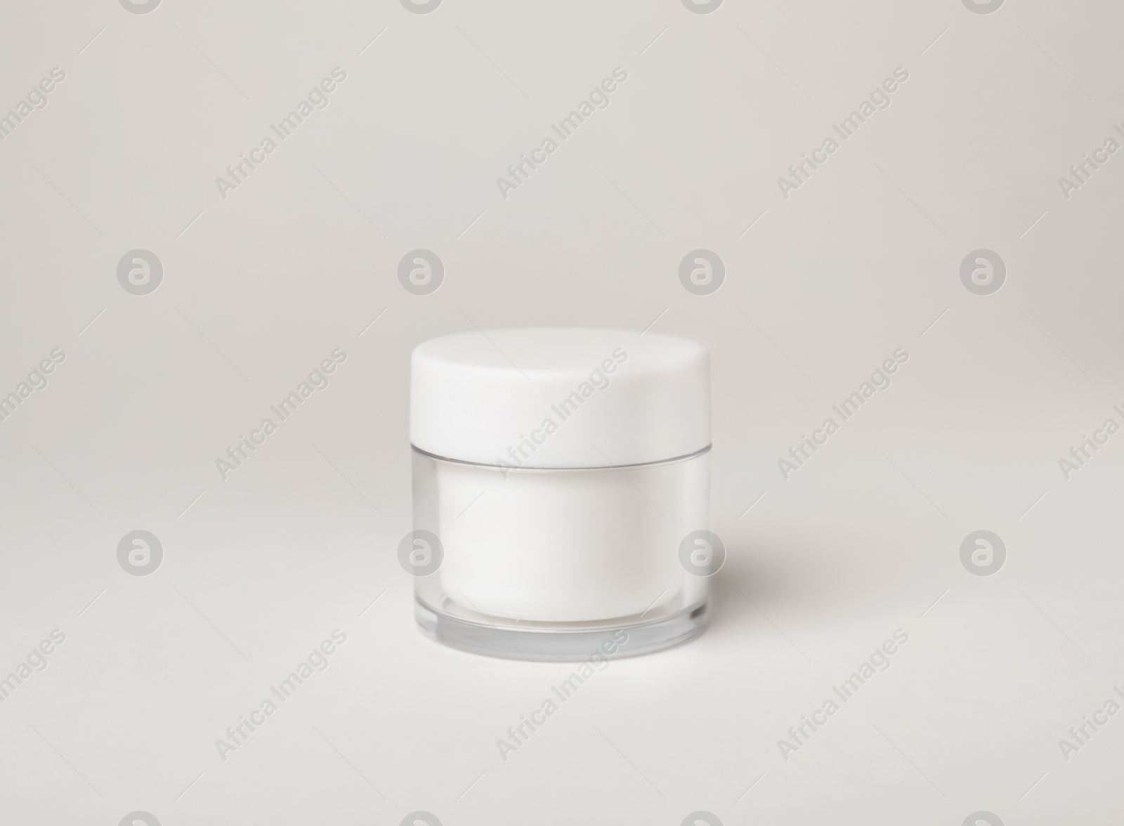 Photo of Jar of cosmetic product on light background