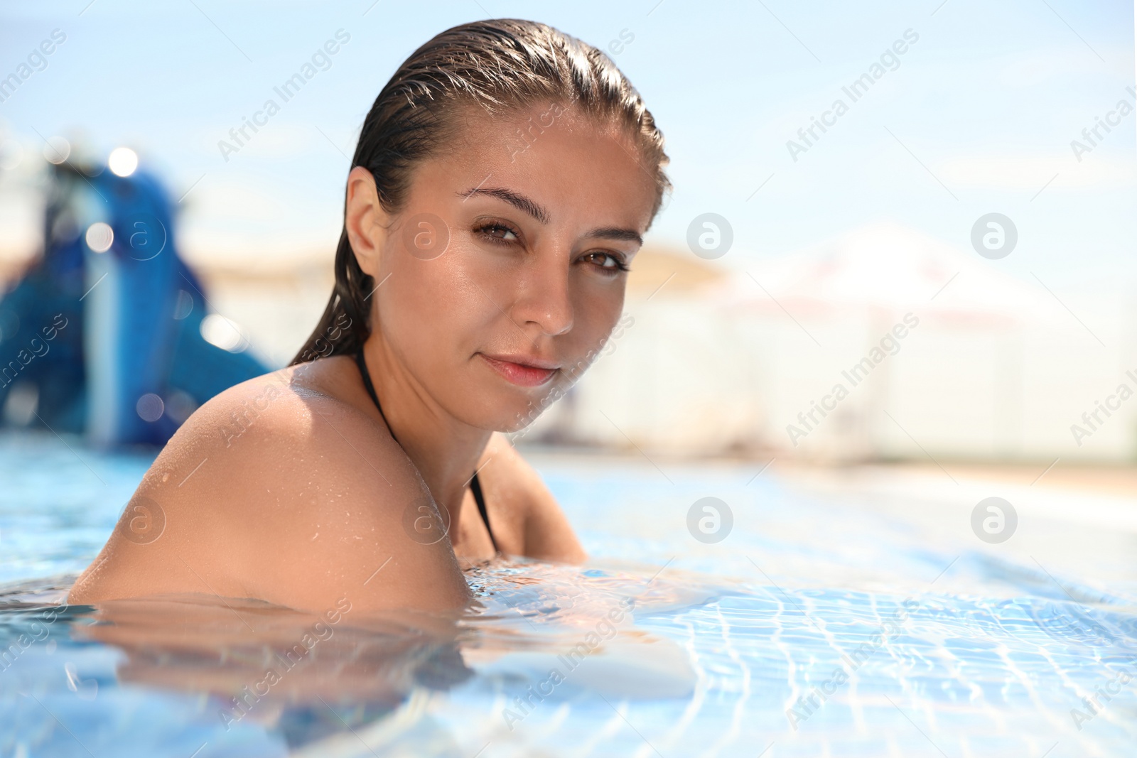 Photo of Beautiful young woman in outdoor swimming pool