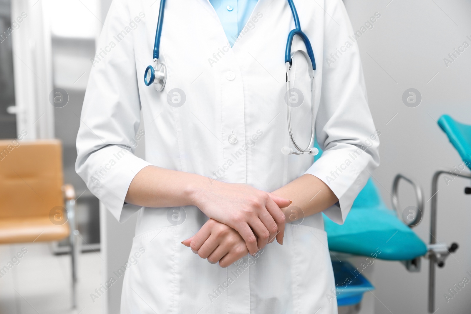 Photo of Young gynecologist in white coat at workplace, closeup