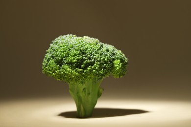 Fresh raw broccoli on beige background, closeup