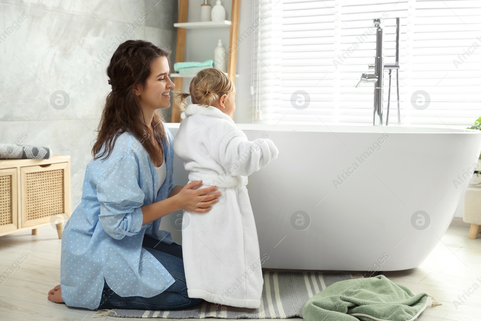 Photo of Mother with her daughter after bath at home