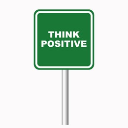 Green road sign with phrase Think Positive on white background