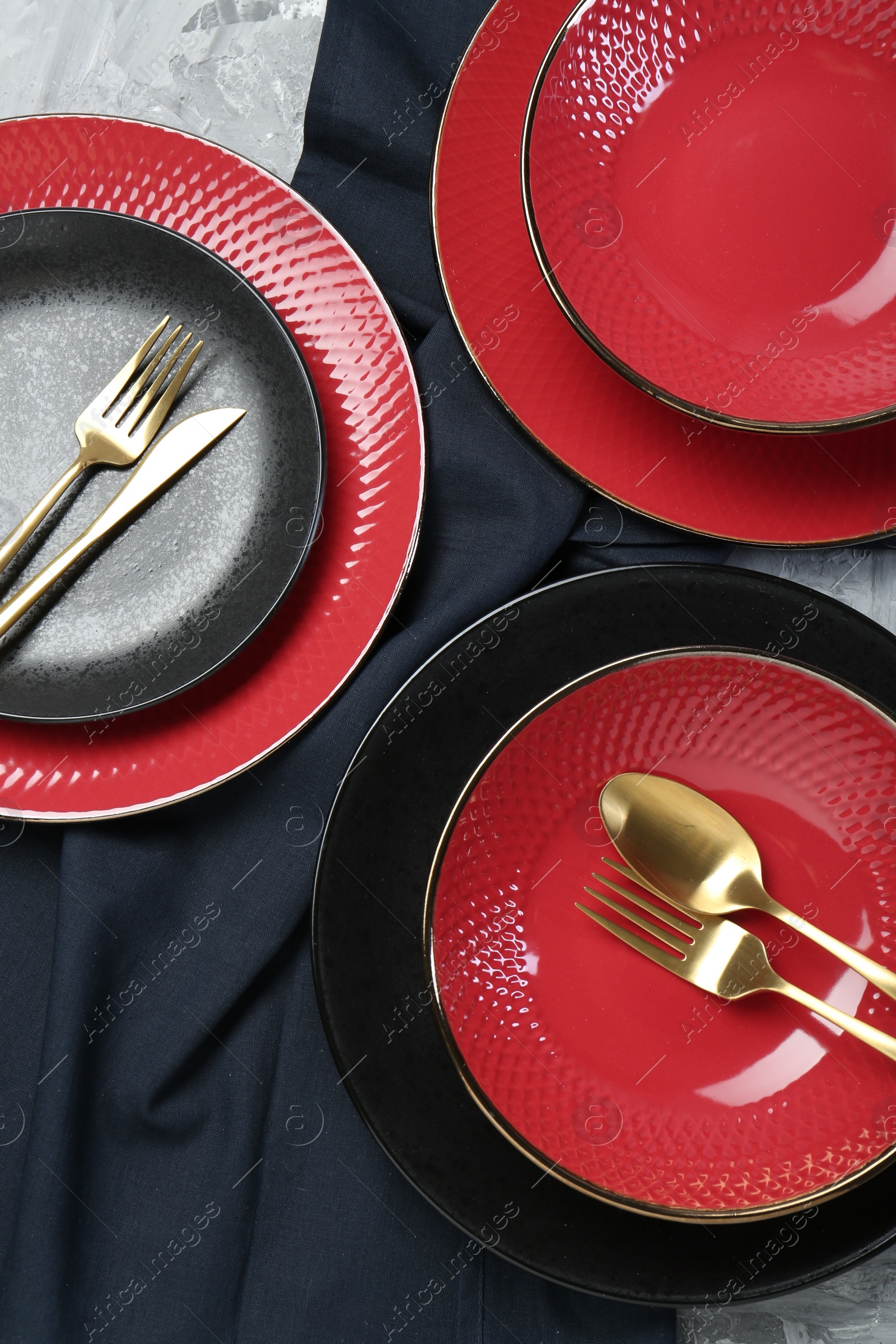 Photo of Stylish ceramic plates and cutlery on table, flat lay