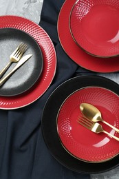 Photo of Stylish ceramic plates and cutlery on table, flat lay