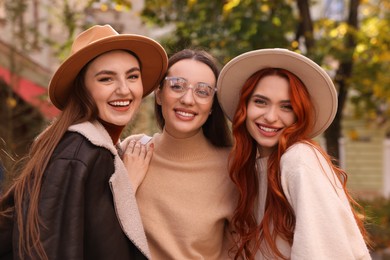 Photo of Portrait of happy friends spending time together outdoors