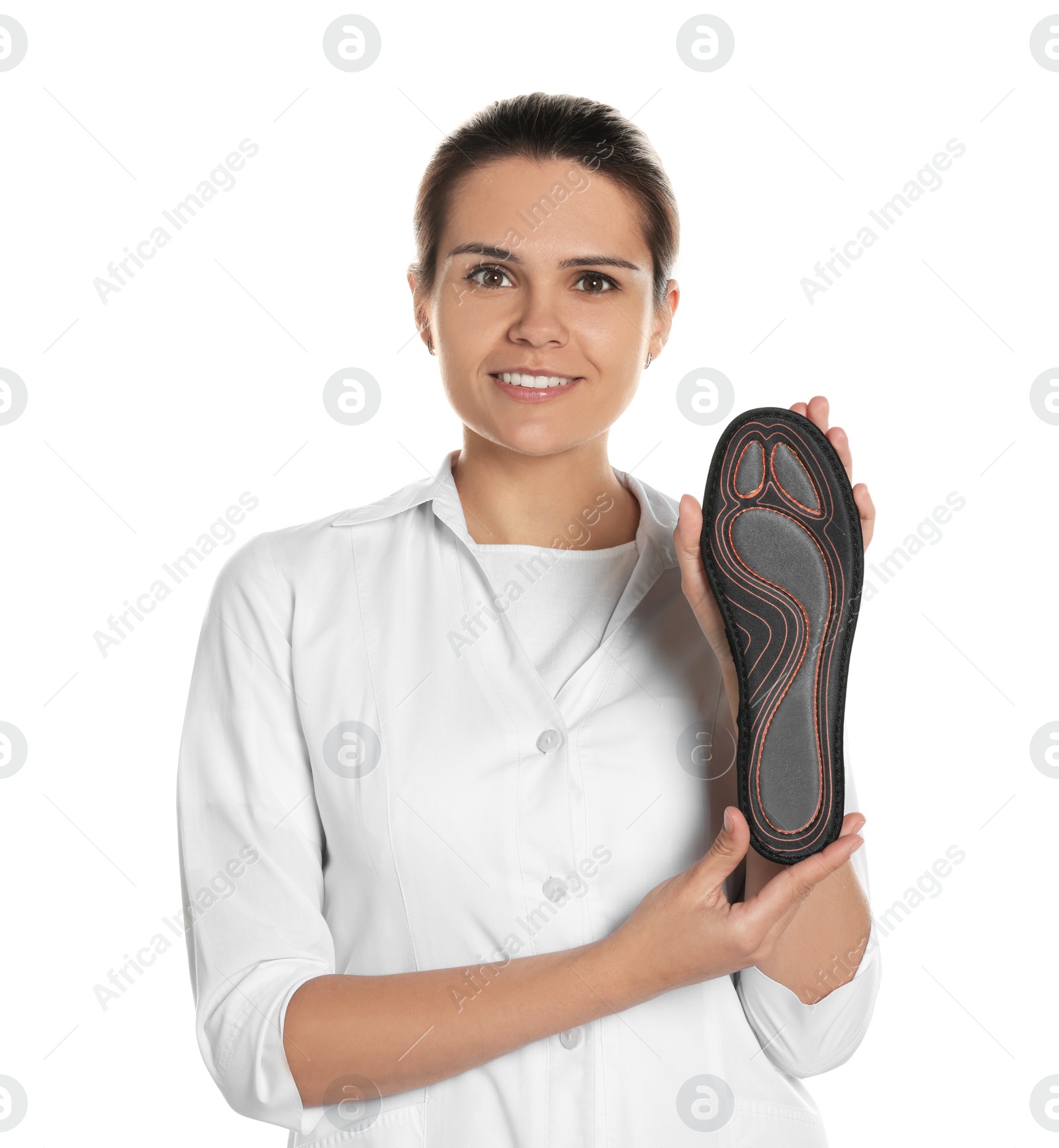 Photo of Beautiful female orthopedist showing insole on white background