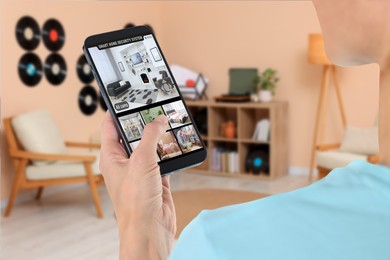 Woman using smart home security system on mobile phone indoors, closeup. Device showing different rooms through cameras