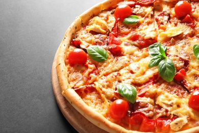 Delicious pizza with tomatoes and sausages on table, closeup