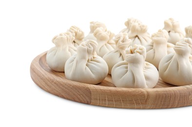 Wooden board with uncooked khinkali (dumplings) isolated on white. Georgian cuisine