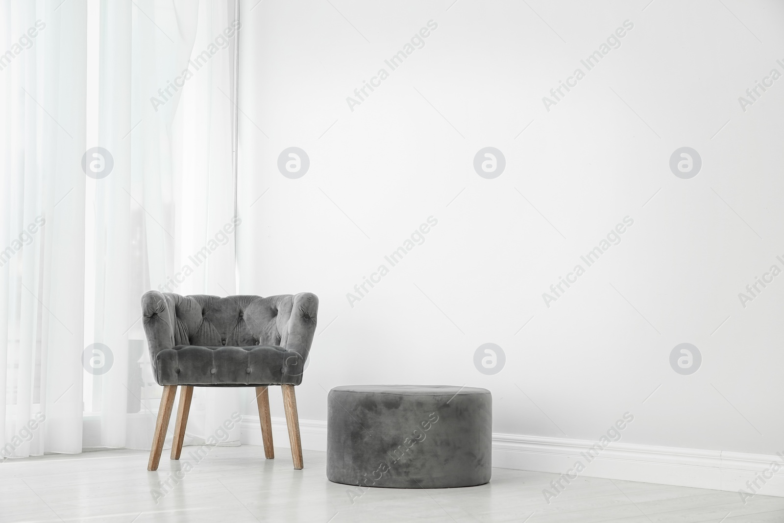 Photo of Living room interior with comfortable armchair near wall