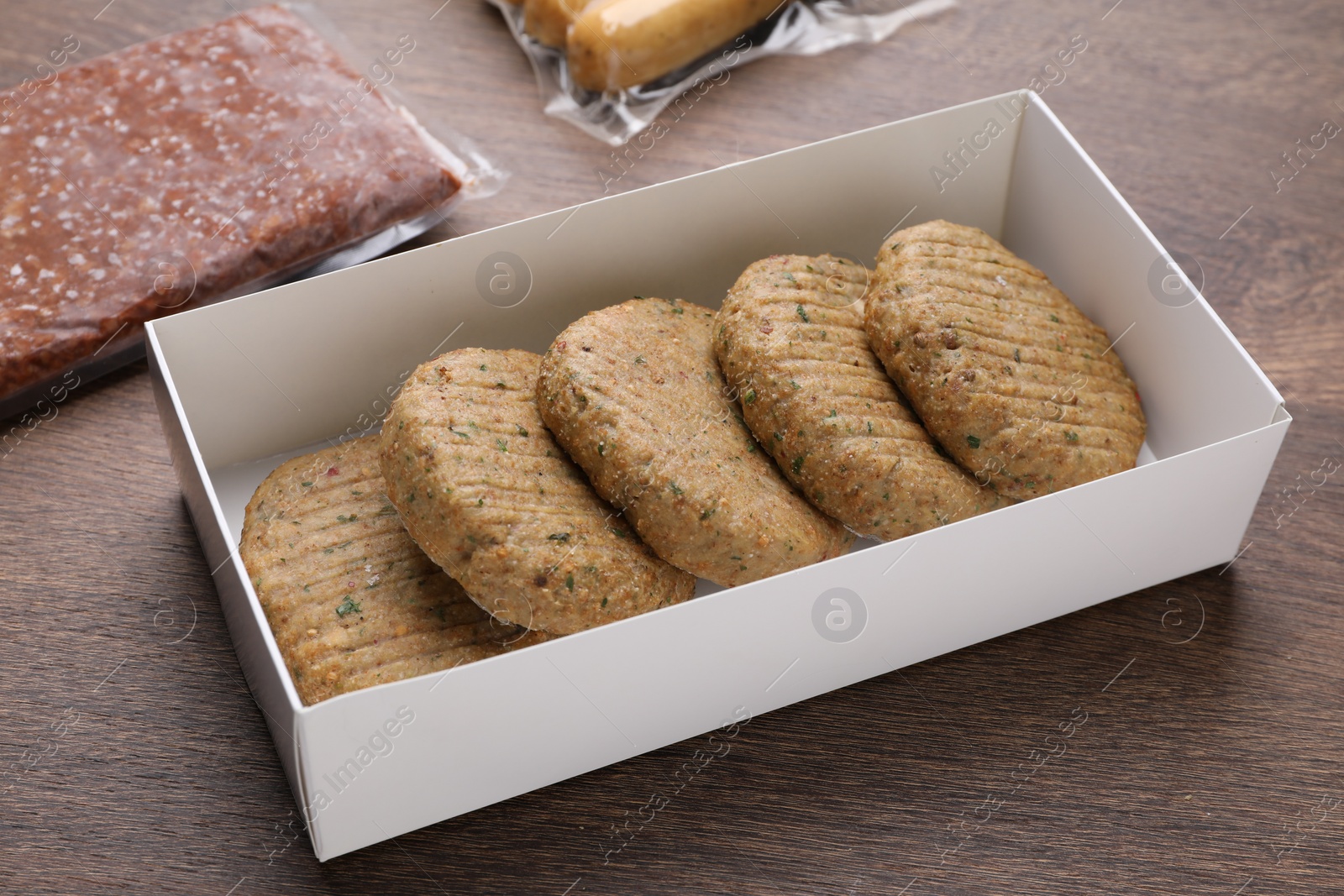 Photo of Different tasty vegan products on wooden table