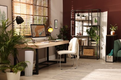 Light room interior with comfortable workplace near window